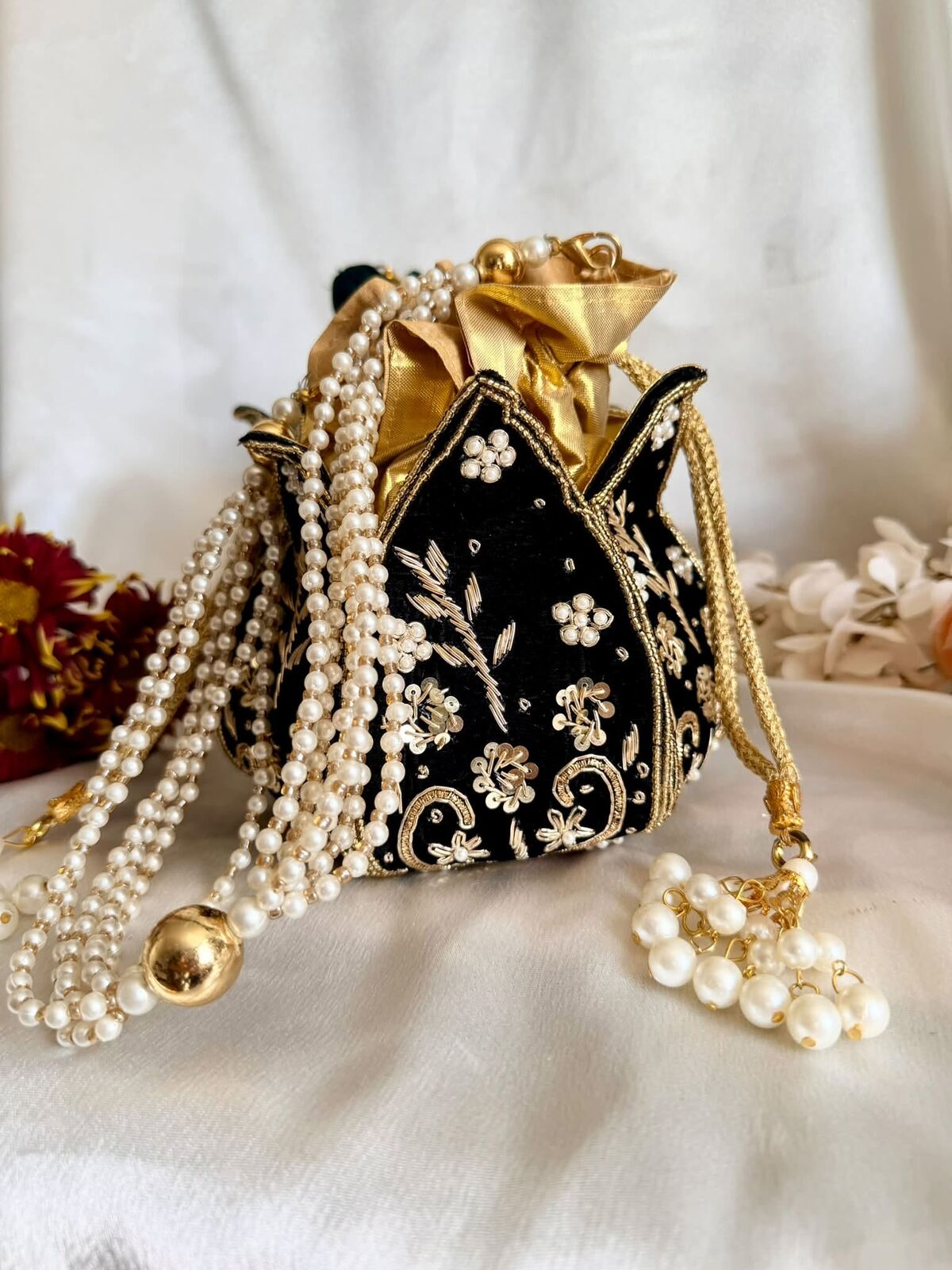 Black velvet potli bag with pearl strands