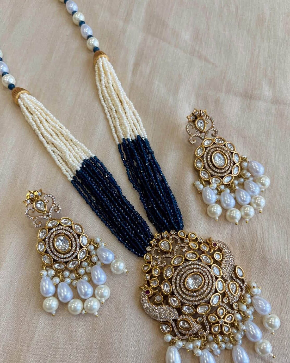 Polki pendant on navy and pearl strands